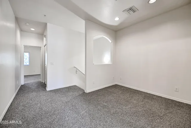 an empty room with mirror and entrance