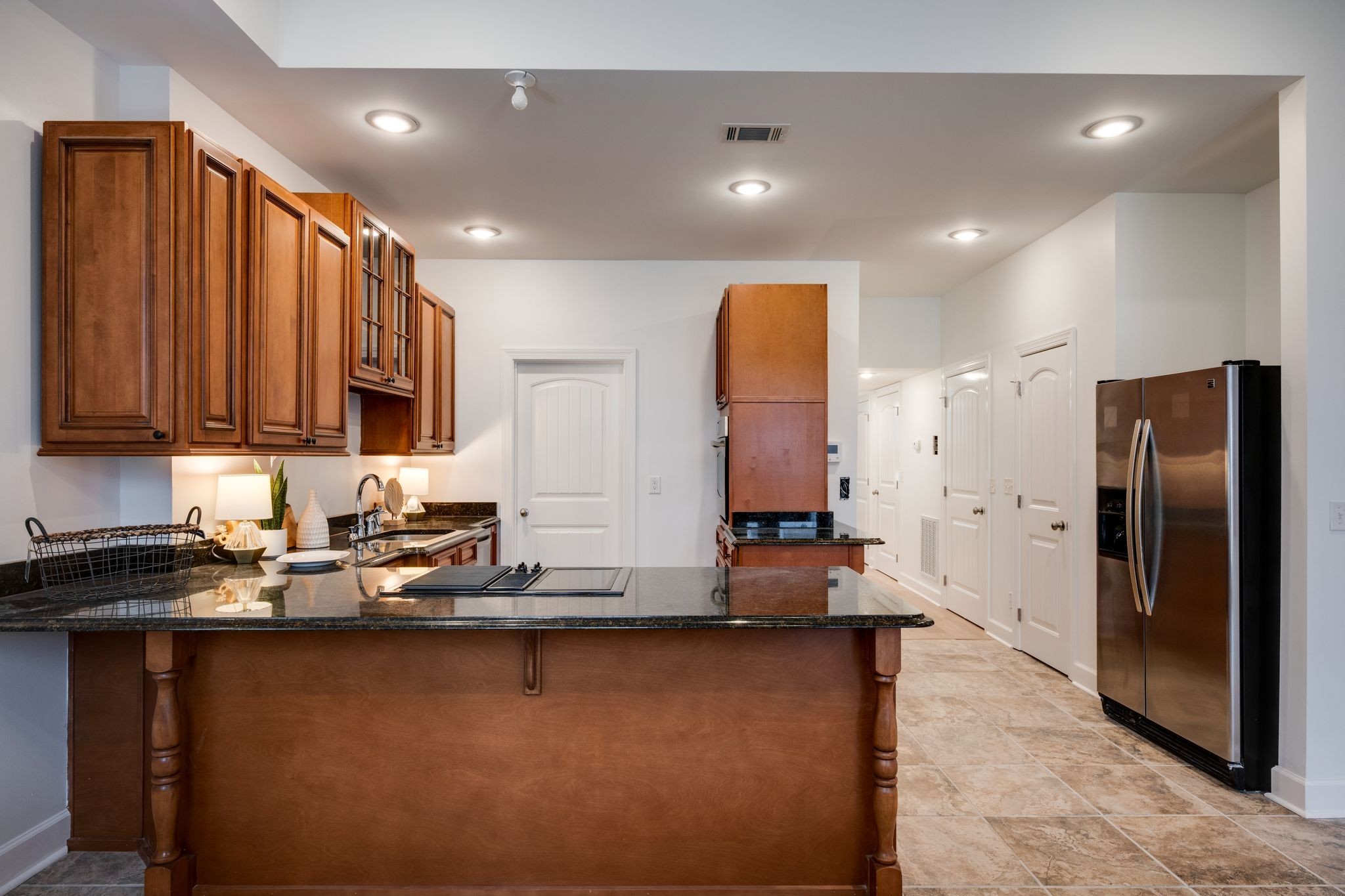 202 West College Street, Unit 4 Dickson, TN 37055 - Photo 13 of 40 a kitchen with stainless steel appliances granite countertop a refrigerator a stove and a sink with wooden cabinets