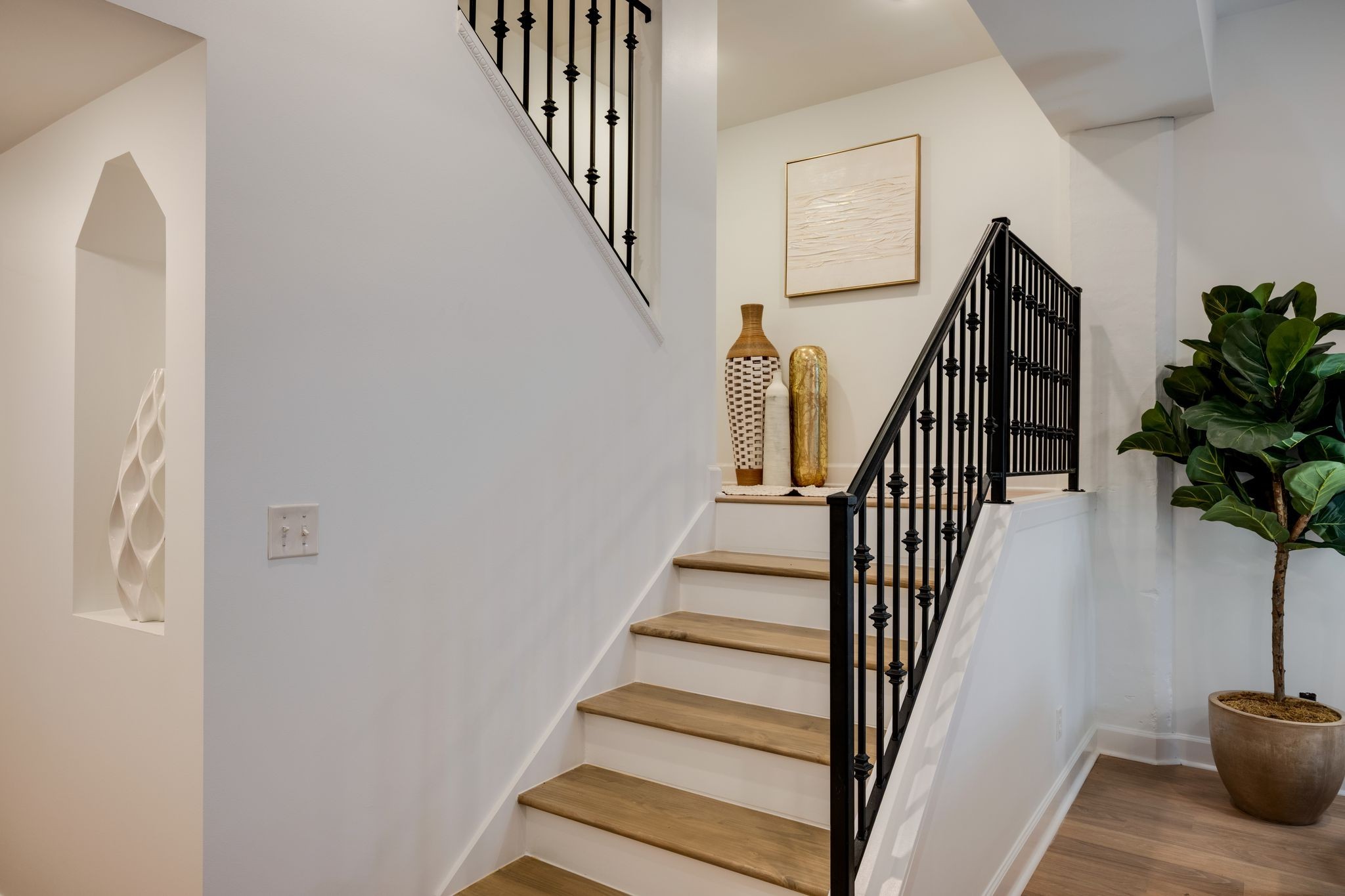 202 West College Street, Unit 4 Dickson, TN 37055 - Photo 18 of 40 a view of staircase with wooden floor and a potted plant