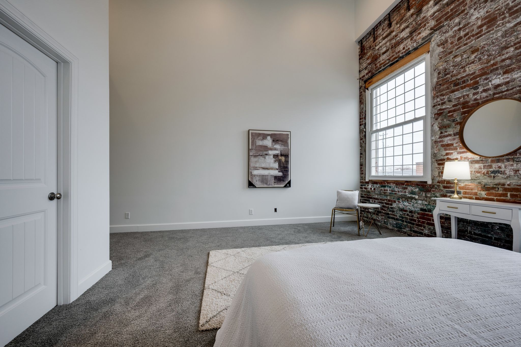 202 West College Street, Unit 4 Dickson, TN 37055 - Photo 29 of 40 a spacious bedroom with a bed and a chandelier
