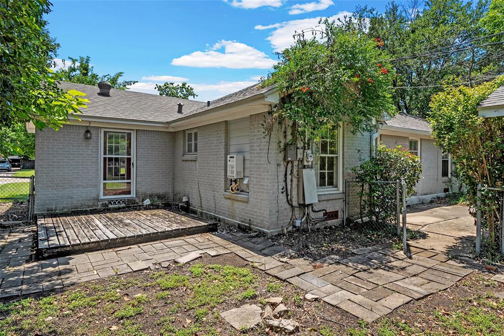 3225 Windsor Avenue Waco, TX 76708 - Photo 22 of 25 Rear exterior featuring light grey brick siding and a grey shingle roof