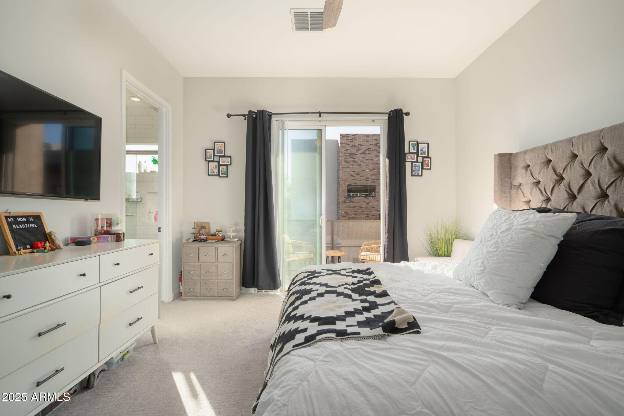 6301 North 12th Street, Unit 6 Phoenix, AZ 85014 - Photo 11 of 18 a bedroom with a large bed and a flat tv screen on dresser