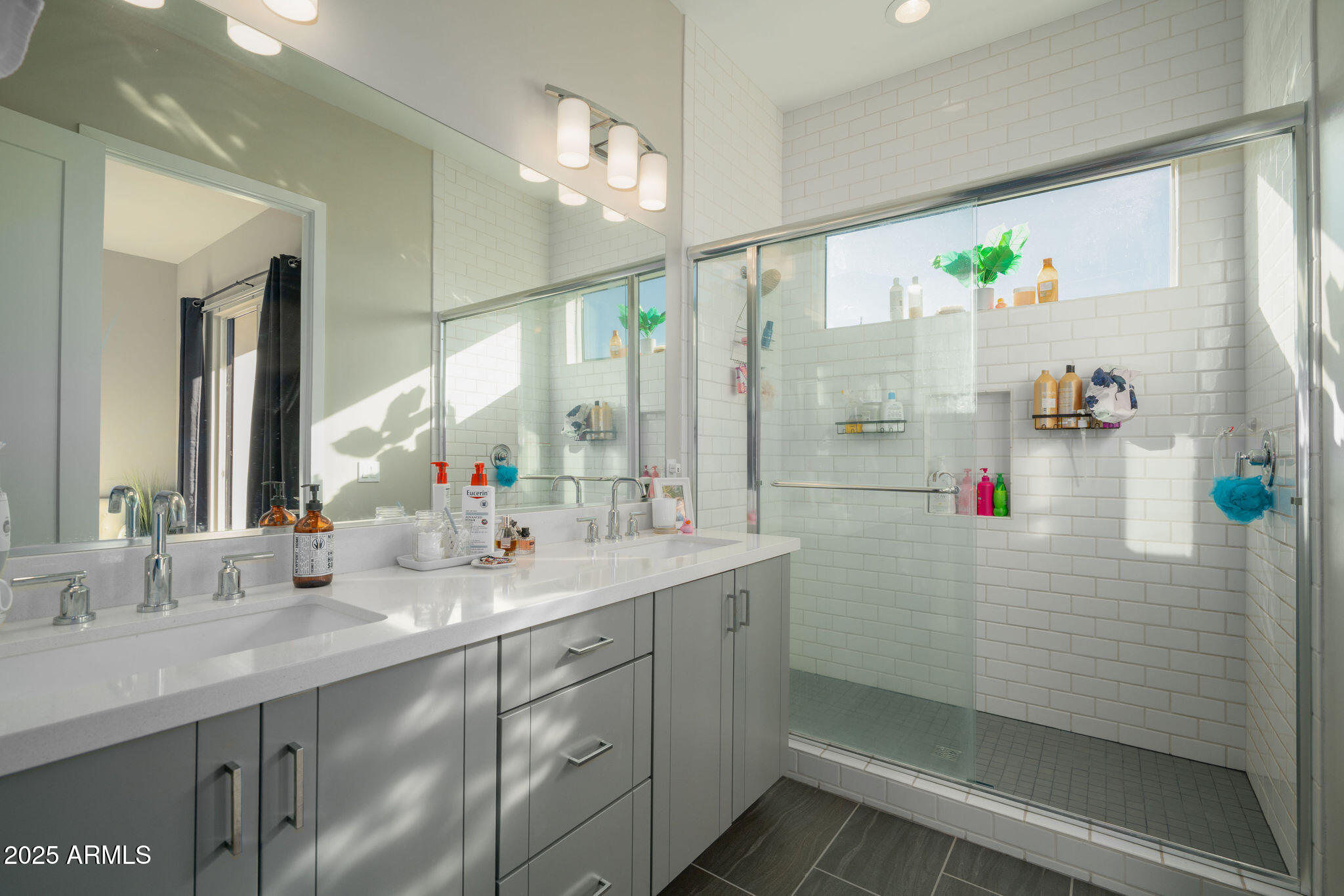 6301 North 12th Street, Unit 6 Phoenix, AZ 85014 - Photo 13 of 18 a bathroom with a shower sink and mirror