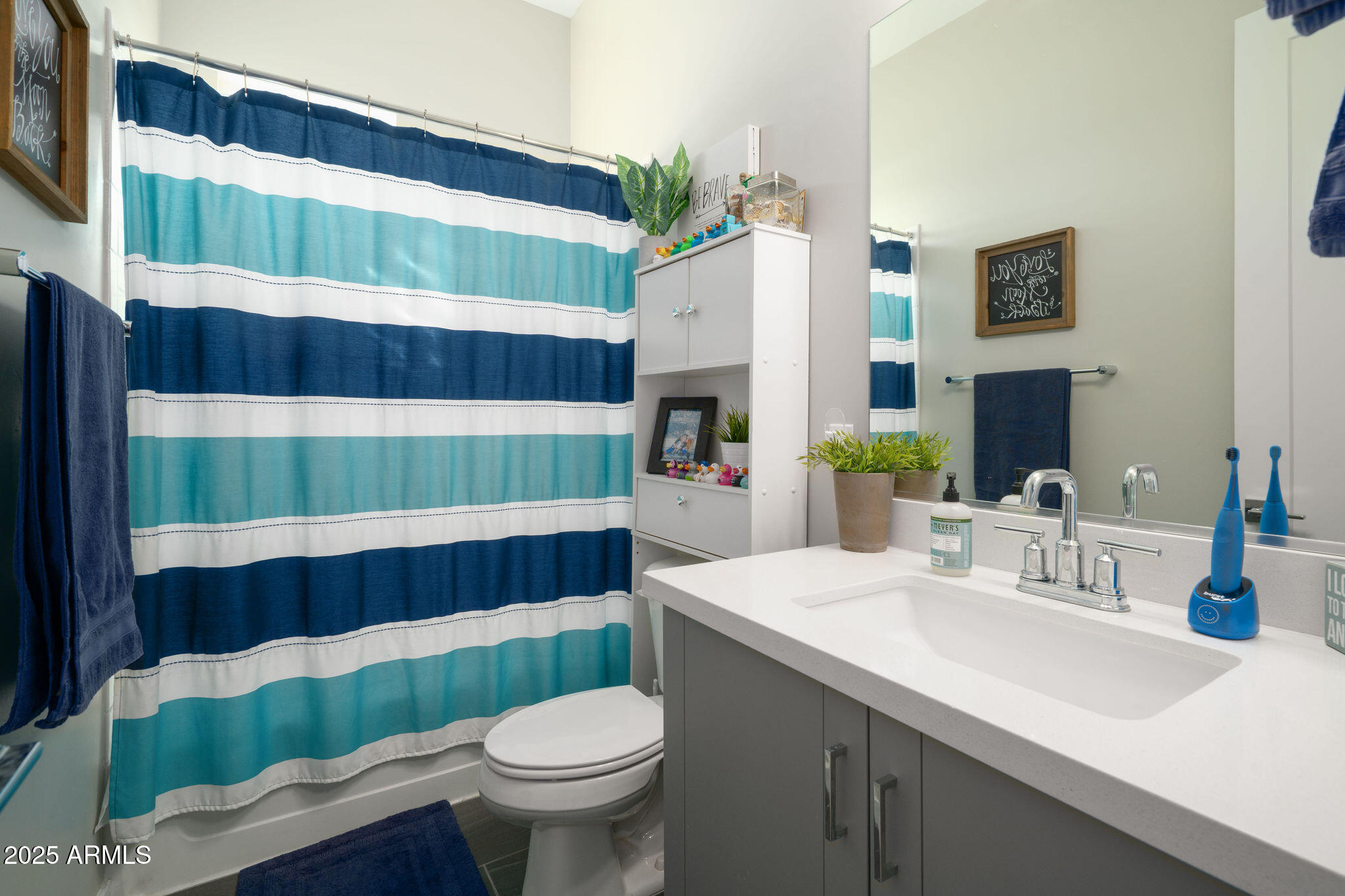 6301 North 12th Street, Unit 6 Phoenix, AZ 85014 - Photo 17 of 18 a bathroom with a sink a toilet and shower curtain