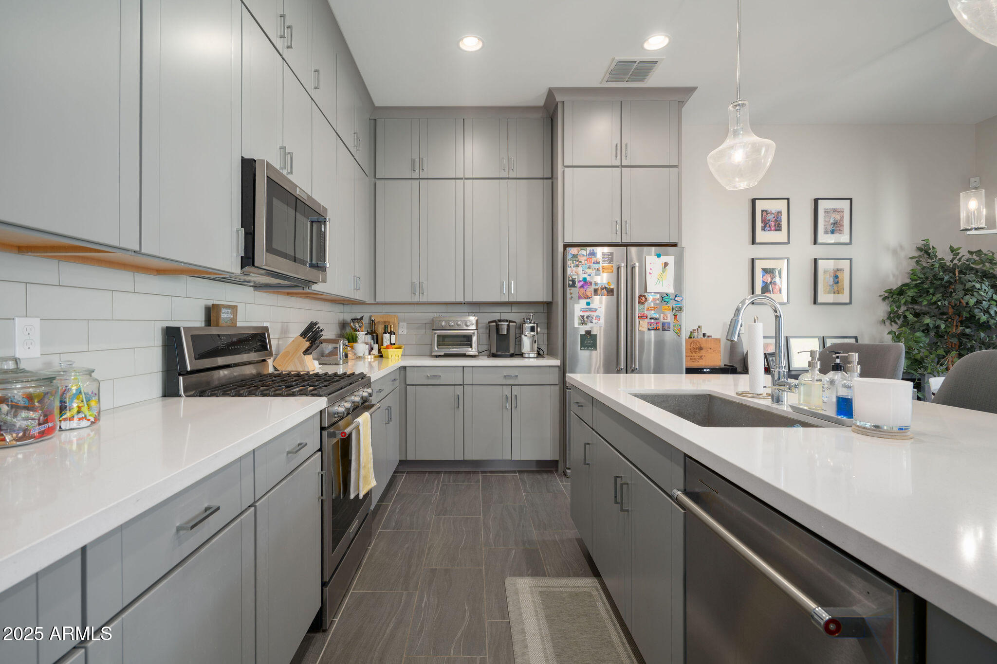 6301 North 12th Street, Unit 6 Phoenix, AZ 85014 - Photo 5 of 18 a kitchen with stainless steel appliances granite countertop a sink a stove and a refrigerator