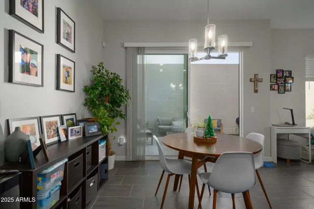 a view of a dining room with furniture and a chandelier