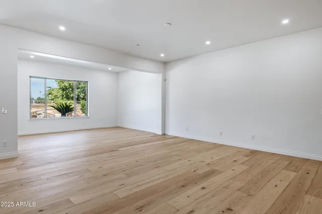 a kitchen with stainless steel appliances granite countertop a sink a stove and a refrigerator