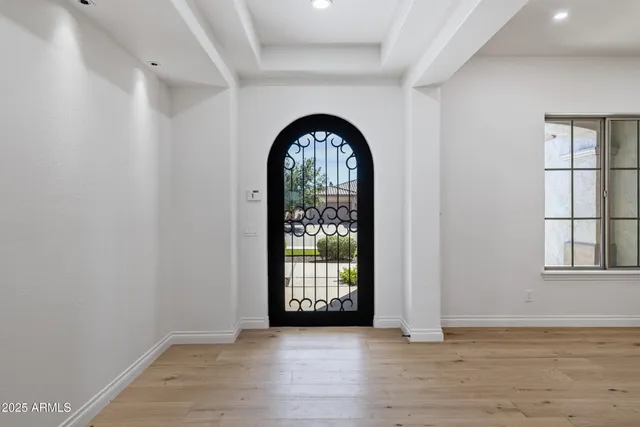 a view of a livingroom with a large window and wooden floor