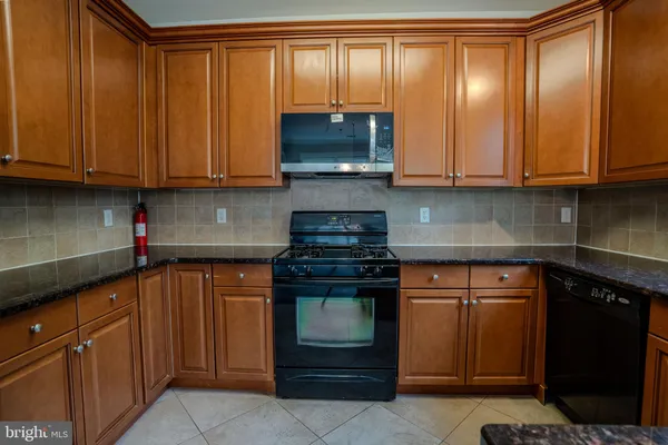a kitchen with stainless steel appliances granite countertop a stove sink and microwave
