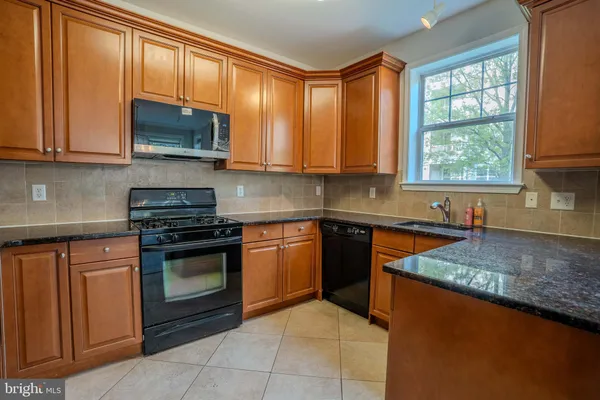 a kitchen with stainless steel appliances granite countertop cabinets and a counter top space