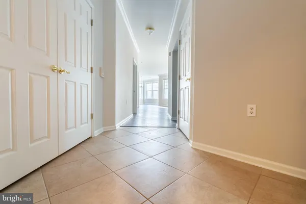 an empty room with wooden floor and fireplace