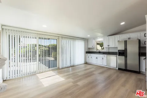 a view of a kitchen with a sink and stainless steel appliances