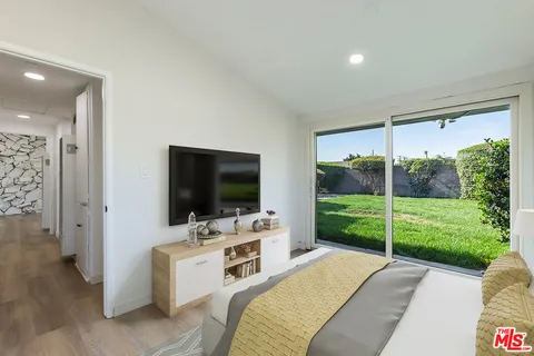 a bedroom with furniture and flat screen tv