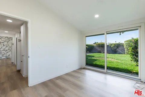 a view of a room with wooden floor and garden