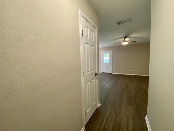 a view of a room with wooden floor