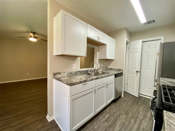 a kitchen with a sink stove and cabinets