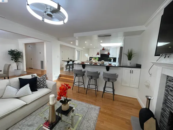 a living room with furniture and kitchen view