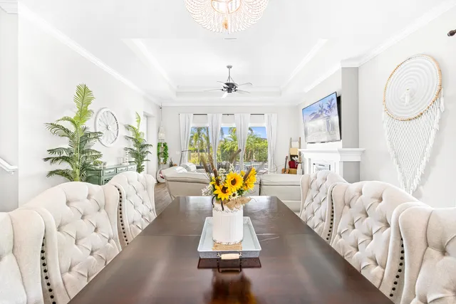 a bed sitting in a bedroom next to a window with a chandelier