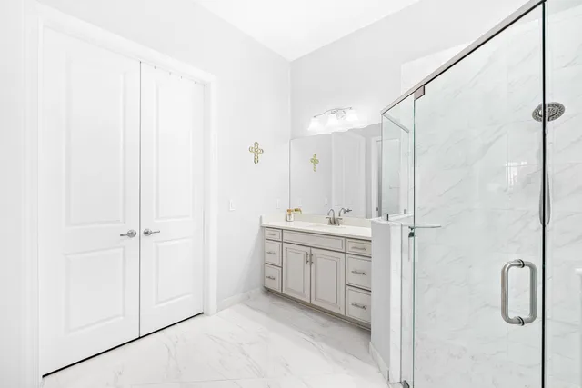 a bathroom with a granite countertop sink mirror vanity and toilet