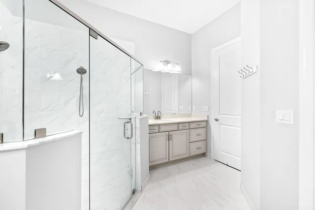 a bedroom with two beds and a large window