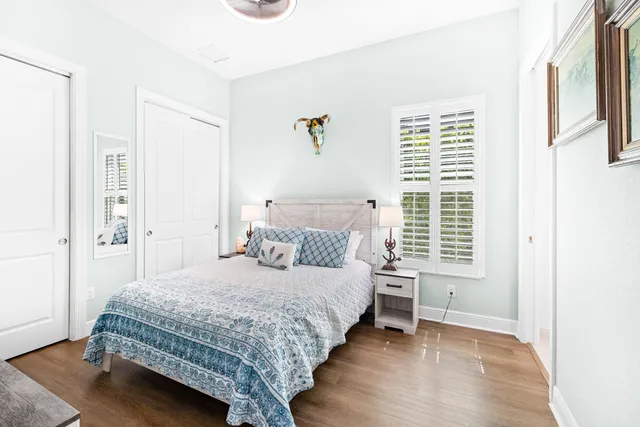 a bedroom with a bed and a large mirror