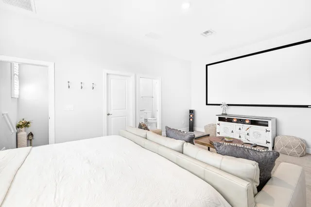a bathroom with a granite countertop sink a toilet and a mirror