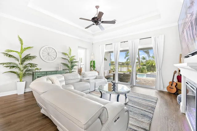 a living room with furniture fireplace and a large window