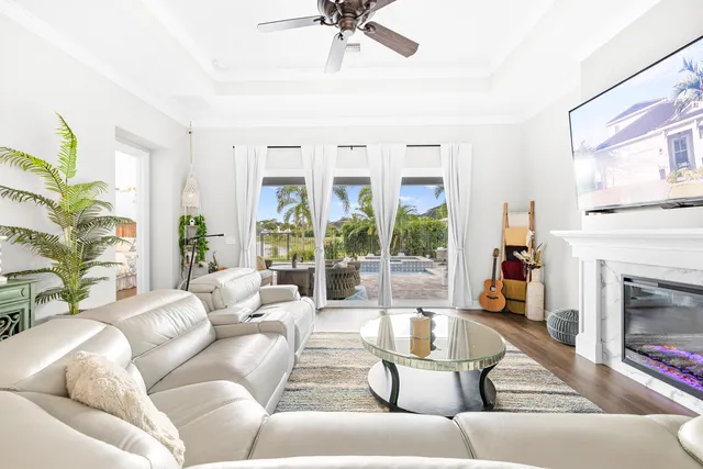 a living room with furniture a fireplace and a large window