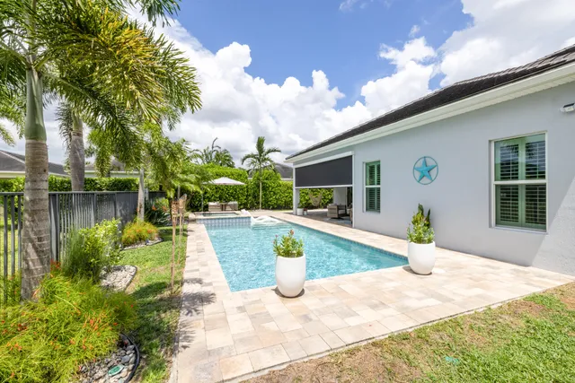 an aerial view of residential houses with outdoor space and swimming pool