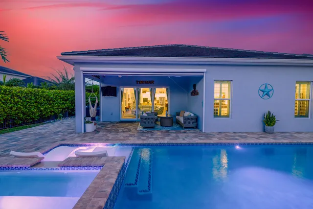 an aerial view of residential houses with outdoor space and swimming pool