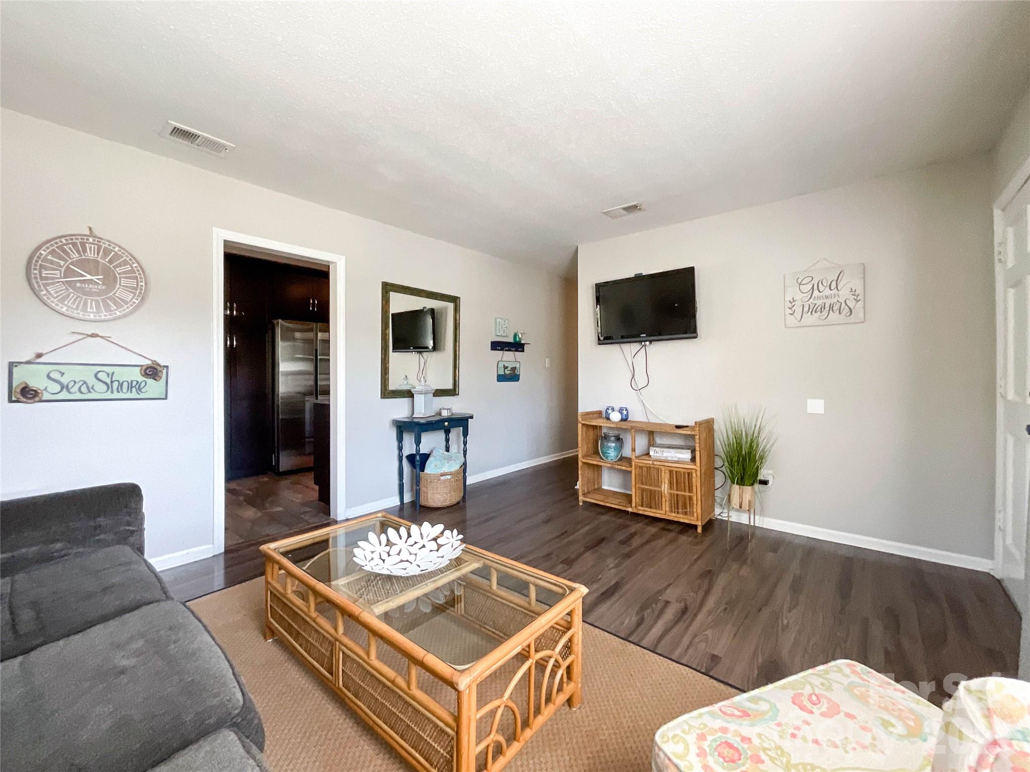 8004 Idlewild Road Indian Trail, NC 28079 - Photo 12 of 33 a living room with furniture and a flat screen tv