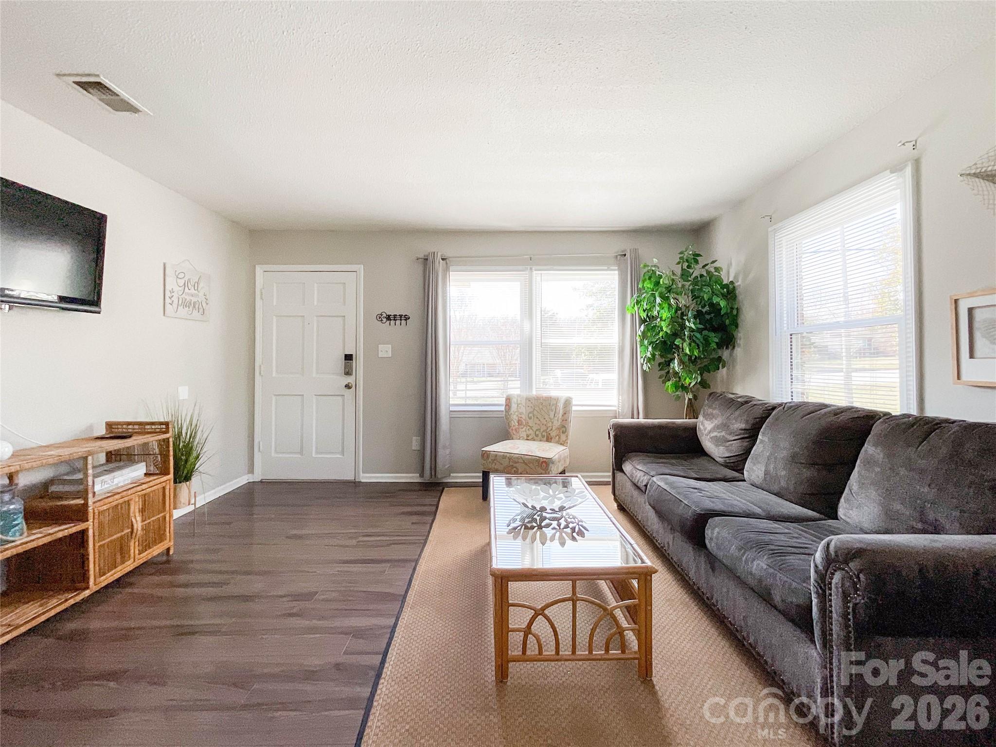 8004 Idlewild Road Indian Trail, NC 28079 - Photo 14 of 33 a living room with furniture and a flat screen tv