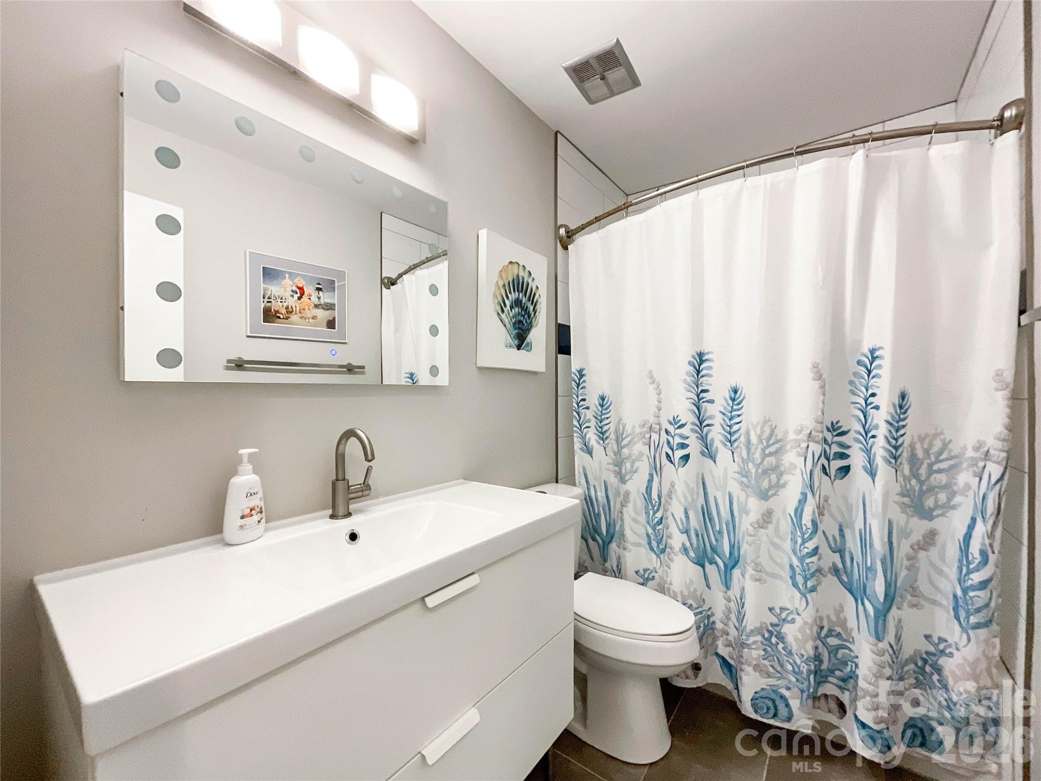 8004 Idlewild Road Indian Trail, NC 28079 - Photo 19 of 33 a bathroom with a sink toilet and shower