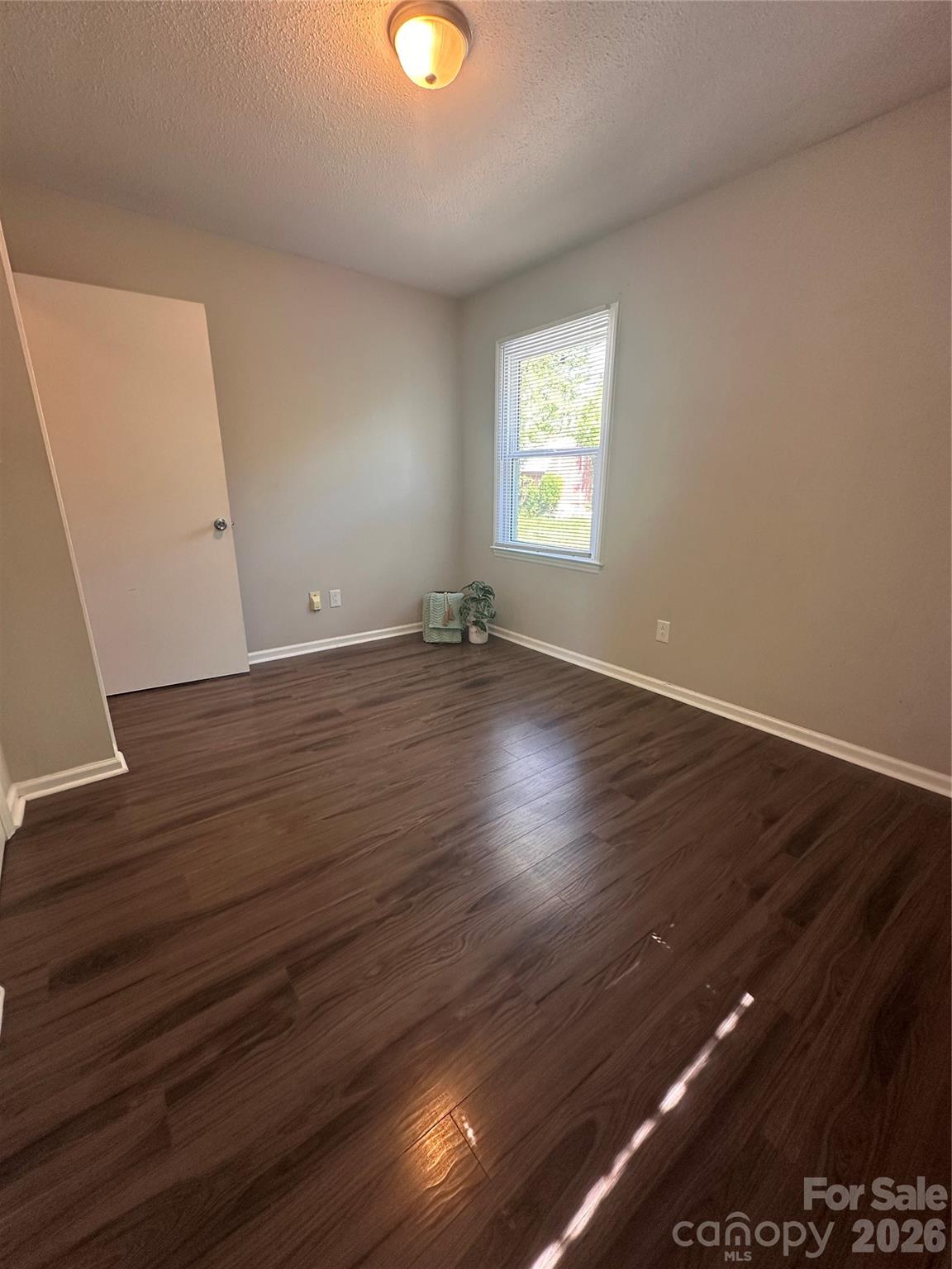 8004 Idlewild Road Indian Trail, NC 28079 - Photo 24 of 33 an empty room with wooden floor and windows