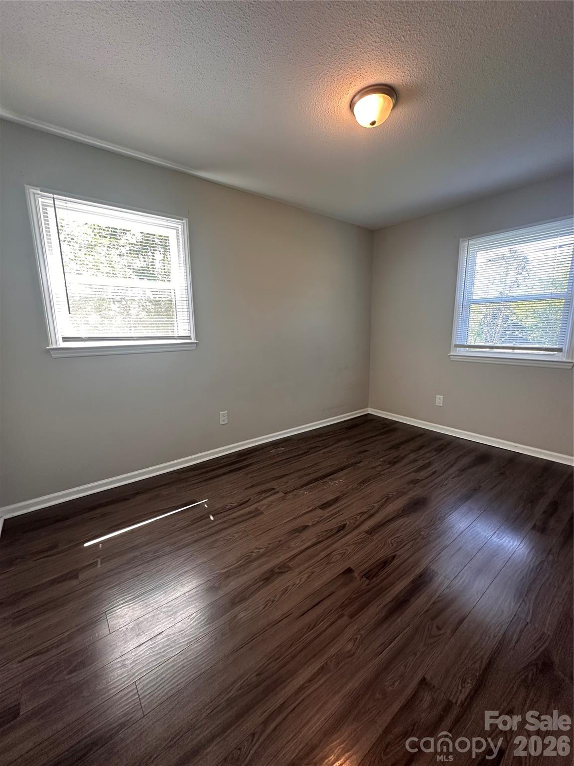 8004 Idlewild Road Indian Trail, NC 28079 - Photo 29 of 33 a view of an empty room with wooden floor and a window