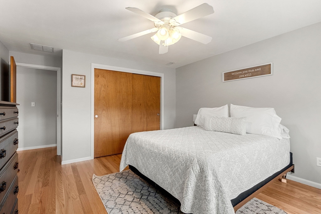 30 Conant Street, Unit 2D Beverly, MA 01915 - Photo 12 of 17 a bedroom with a bed and a chandelier