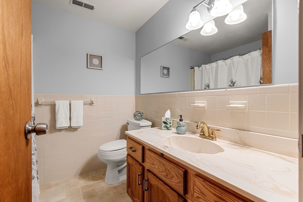30 Conant Street, Unit 2D Beverly, MA 01915 - Photo 13 of 17 a bathroom with a sink a toilet and a mirror