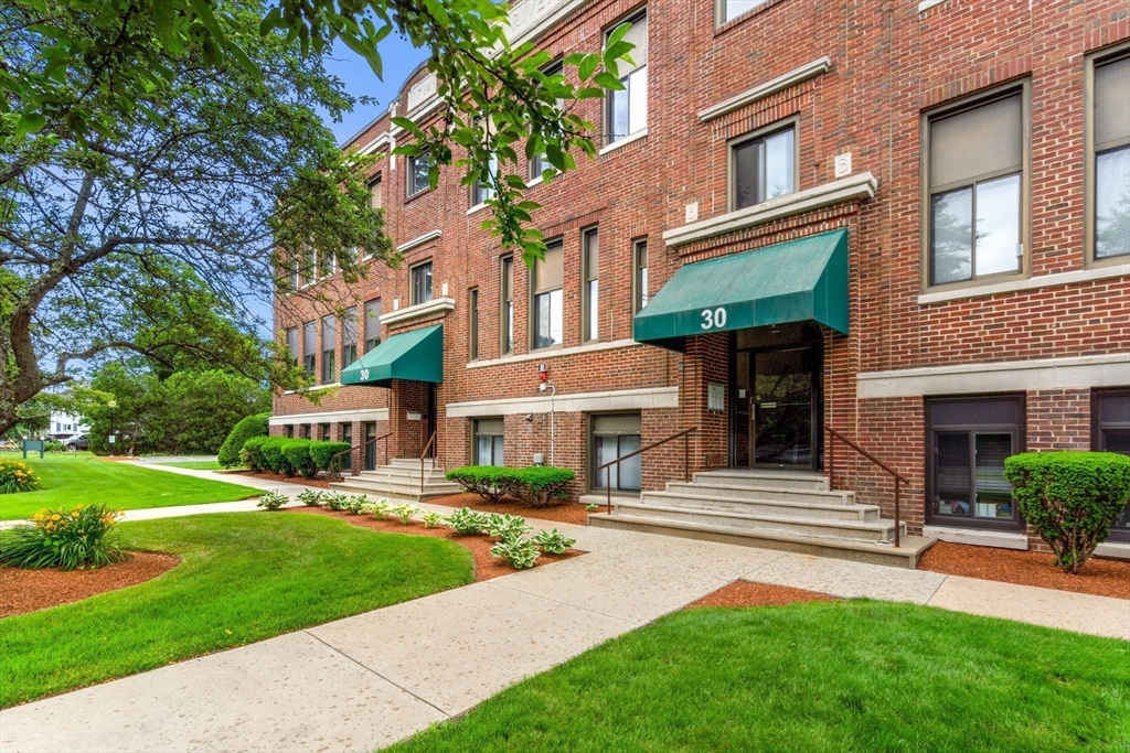 30 Conant Street, Unit 2D Beverly, MA 01915 - Photo 2 of 17 a front view of a building with garden and trees