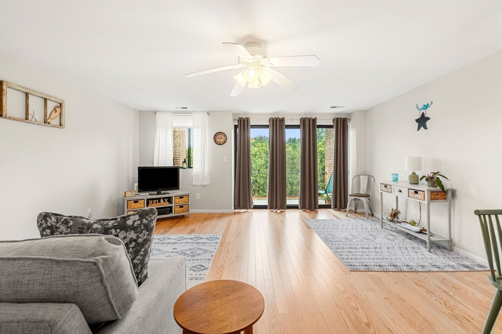 30 Conant Street, Unit 2D Beverly, MA 01915 - Photo 3 of 17 a bedroom with furniture and a flat screen tv