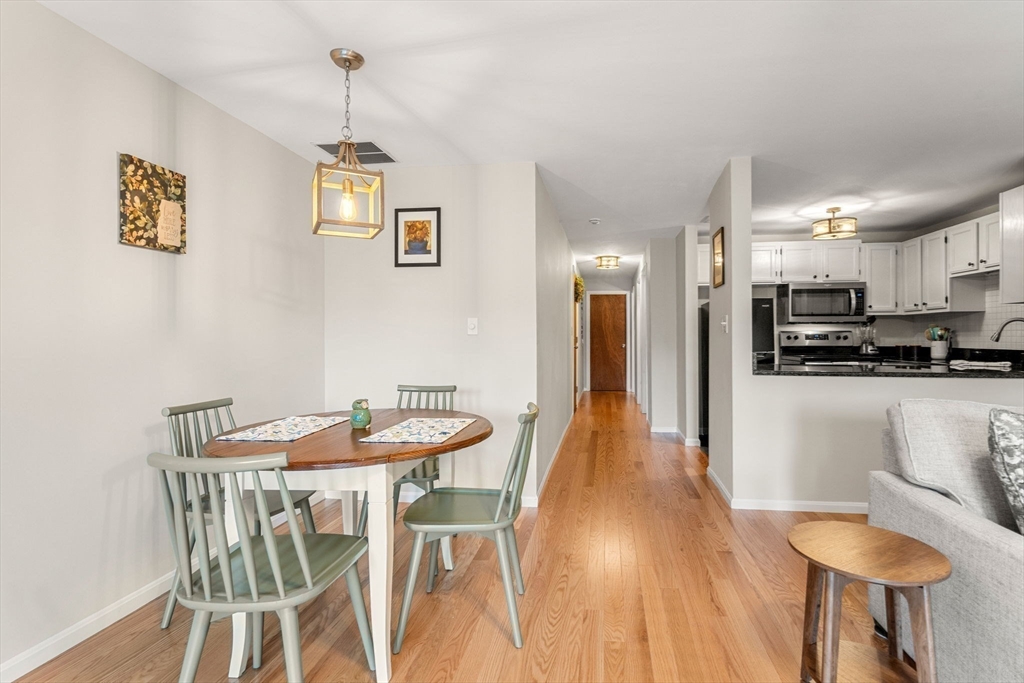 30 Conant Street, Unit 2D Beverly, MA 01915 - Photo 4 of 17 a view of a dining room with furniture and wooden floor