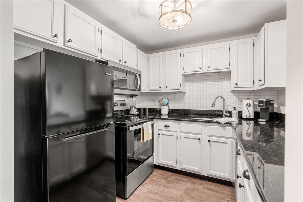 30 Conant Street, Unit 2D Beverly, MA 01915 - Photo 5 of 17 a kitchen with cabinets stainless steel appliances and a sink