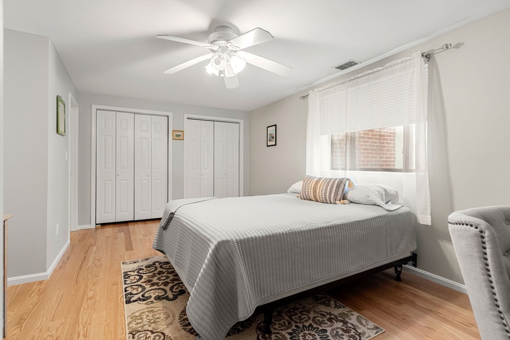 30 Conant Street, Unit 2D Beverly, MA 01915 - Photo 8 of 17 a bedroom with a large bed and a chandelier