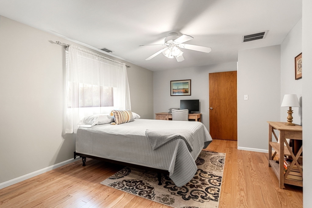 30 Conant Street, Unit 2D Beverly, MA 01915 - Photo 9 of 17 a bedroom with a bed and wooden floor