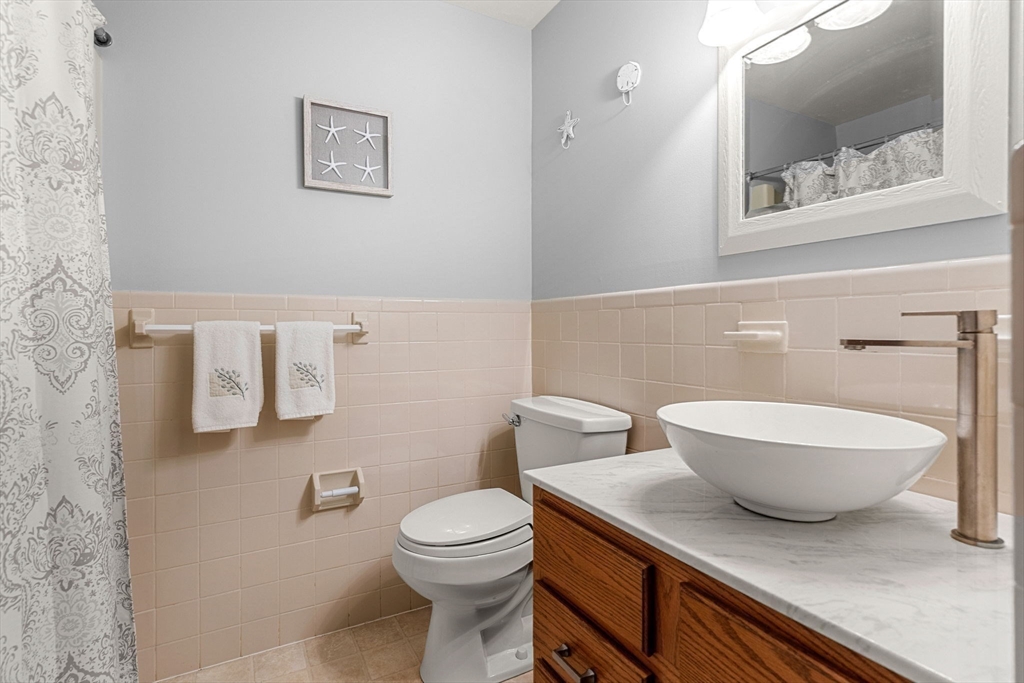30 Conant Street, Unit 2D Beverly, MA 01915 - Photo 10 of 17 a white toilet sitting next to a bathroom sink