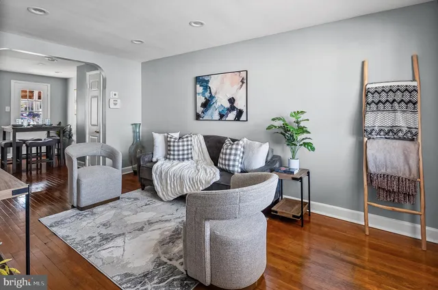 a living room with furniture and wooden floor