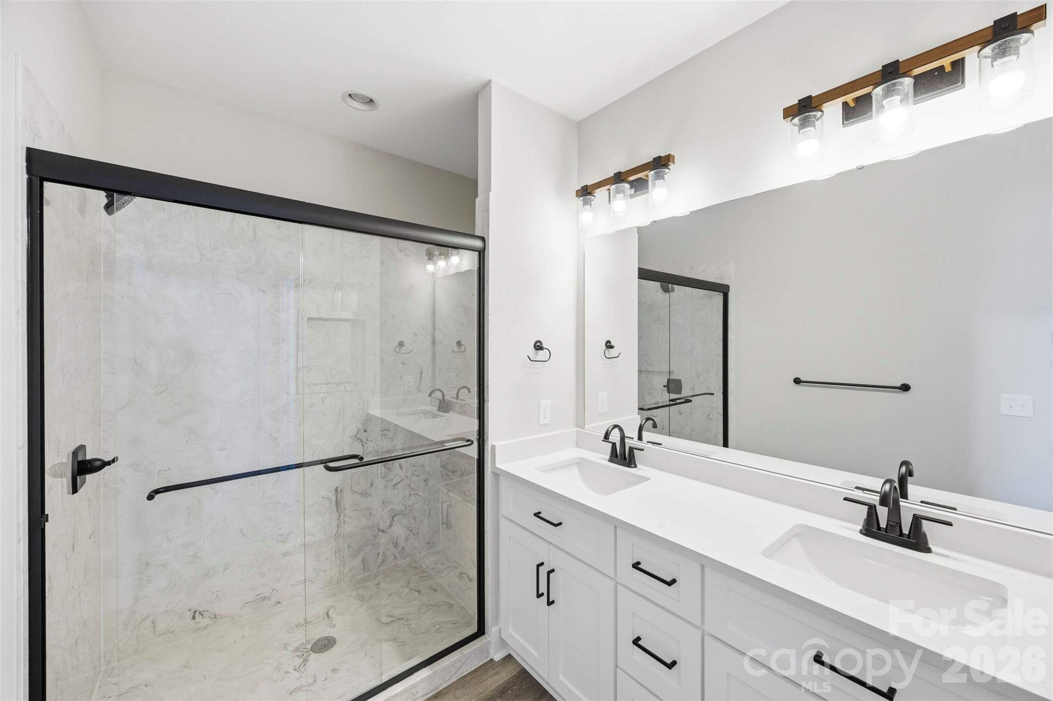 1014 Speight Road Albemarle, NC 28001 - Photo 16 of 28 a bathroom with a double vanity sink mirror and shower