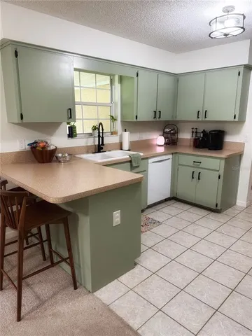 a kitchen with a sink cabinets and window