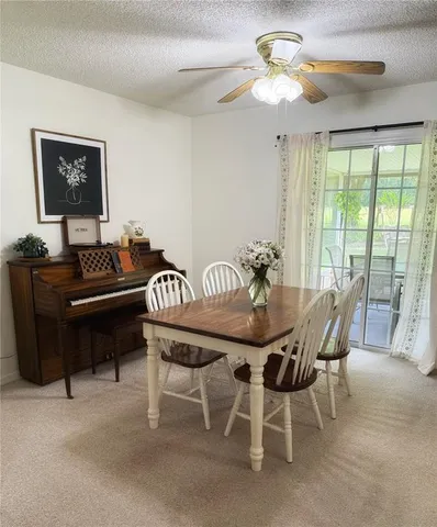 a dining room with furniture and a chandelier