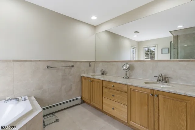 a utility room with cabinets washer and dryer