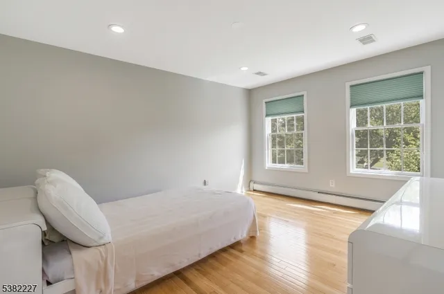 a spacious bedroom with a bed and a large window